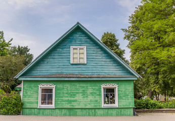 Fototapeta na wymiar Traditional green and blue wooden house in Trakai