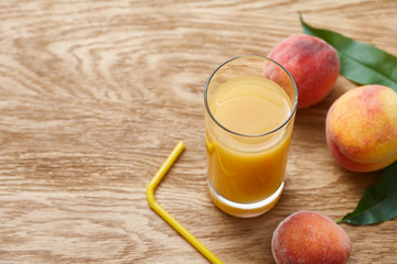 Glass of fresh peach juice and ripe fruits
