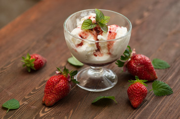 Vanilla ice cream with jam and strawberries