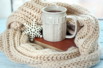 Beautiful winter composition on windowsill with cup of hot drink