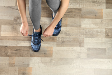 Woman hands tying sport shoes