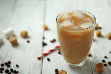 Iced coffee with milk on wooden table