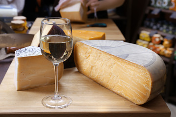 Fresh cheese with wine on the table in cellar