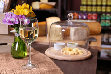 Obraz na płótnie Canvas Fresh cheese with wine on the table in cellar