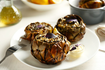 Baked artichokes on white plate