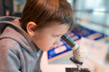 child looking in microscope