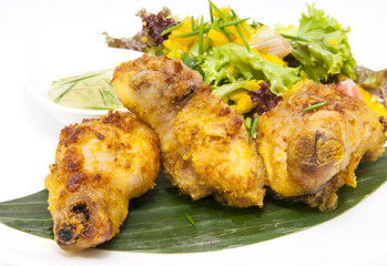 chicken in curry with salad and sauce on a white background in restorne