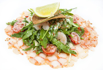 salad greens and shrimp meat on a white background