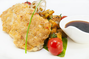 shrimp patties of meat with a salad of eggplant on a white background in restorne