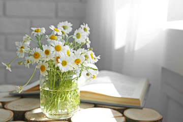 Chamomile bouquet on wooden table