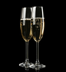 Two champagne glasses on black background