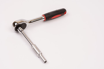 Rachet hand tools with socket over white background with copy sp