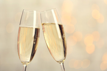 Two champagne glasses on light background