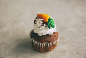Carrot chocolate muffin on grey background