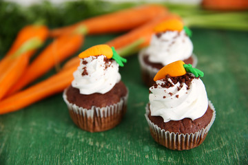 Carrot chocolate muffins on wooden table