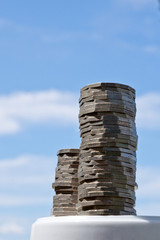 Piles of coins with sky background