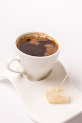 White cup of coffee with turkish delight on plate isolated with