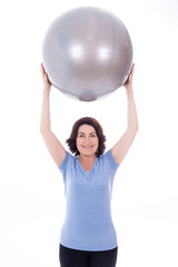 Fototapeta premium happy sporty mature woman with fitness ball isolated on white