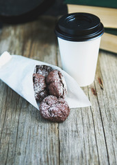 Chocolate cookies in bags with a paper cup of coffee