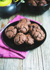 Homemade chocolate chip cookies on a black plate