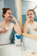 Woman applying moisturizing skin cream. Skincare.