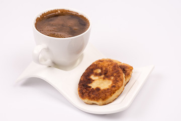White cup of coffee with homemade donuts isolated over white bac