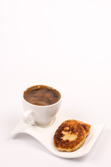 White cup of coffee with homemade donuts isolated over white bac