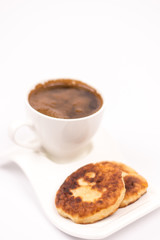 White cup of coffee with homemade donuts isolated over white bac