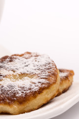Closeup macro powdered donuts isolated over white background