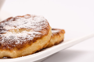 Closeup macro powdered donuts isolated over white background
