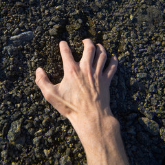 Hand clinging stony ground