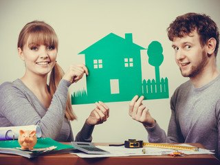 Young couple with ecological green house.