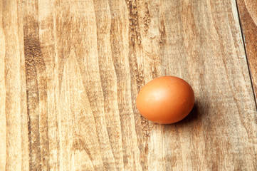 The image of eggs on a wooden table.