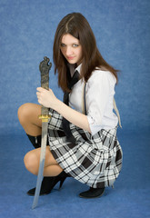 Beautiful girl in a skirt with the Japanese sword