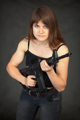 Beautiful young sexual woman - soldier with a rifle