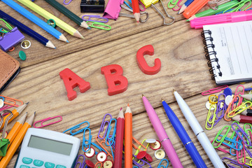 ABC word and office tools on wooden table