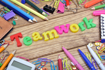 Teamwork word and office tools on wooden table