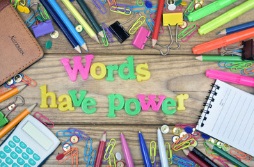 Words have power word and office tools on wooden table