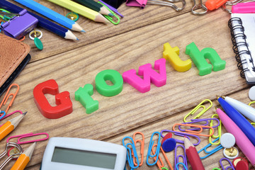 Growth word and office tools on wooden table