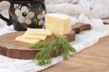 Cheese and dill on a wooden board