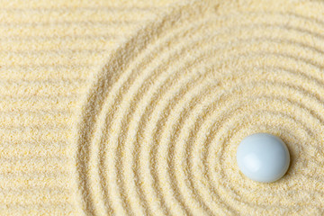 Fototapeta na wymiar White drop on surface of yellow sand - abstract background