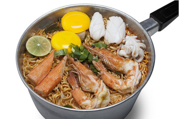 Bowl of spicy instant noodles isolated on white background. Topping with eggs, lemon, pork , crispy pork, sausage and coriander