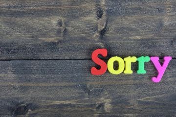 Sorry on wooden table