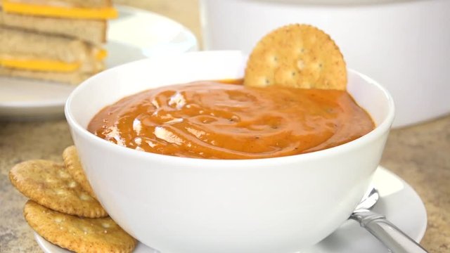 Serving tomato bisque with crackers
