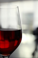 Glass of red wine on blurred background