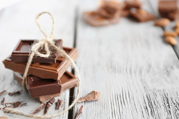 Chocolate pieces on wooden background