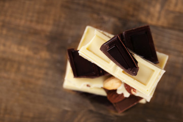 Mix of chocolate with nuts on wooden table