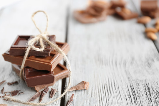 Chocolate pieces on wooden background