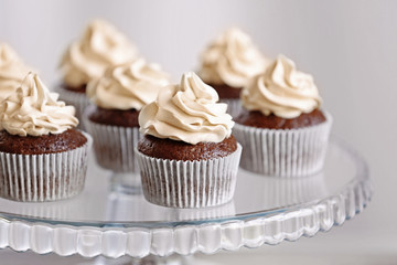 Tasty cupcakes on glass stand