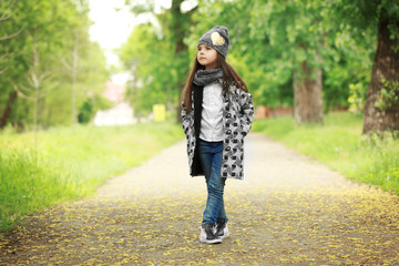 Little girl wearing stylish clothes outdoors. Fashion kid concept